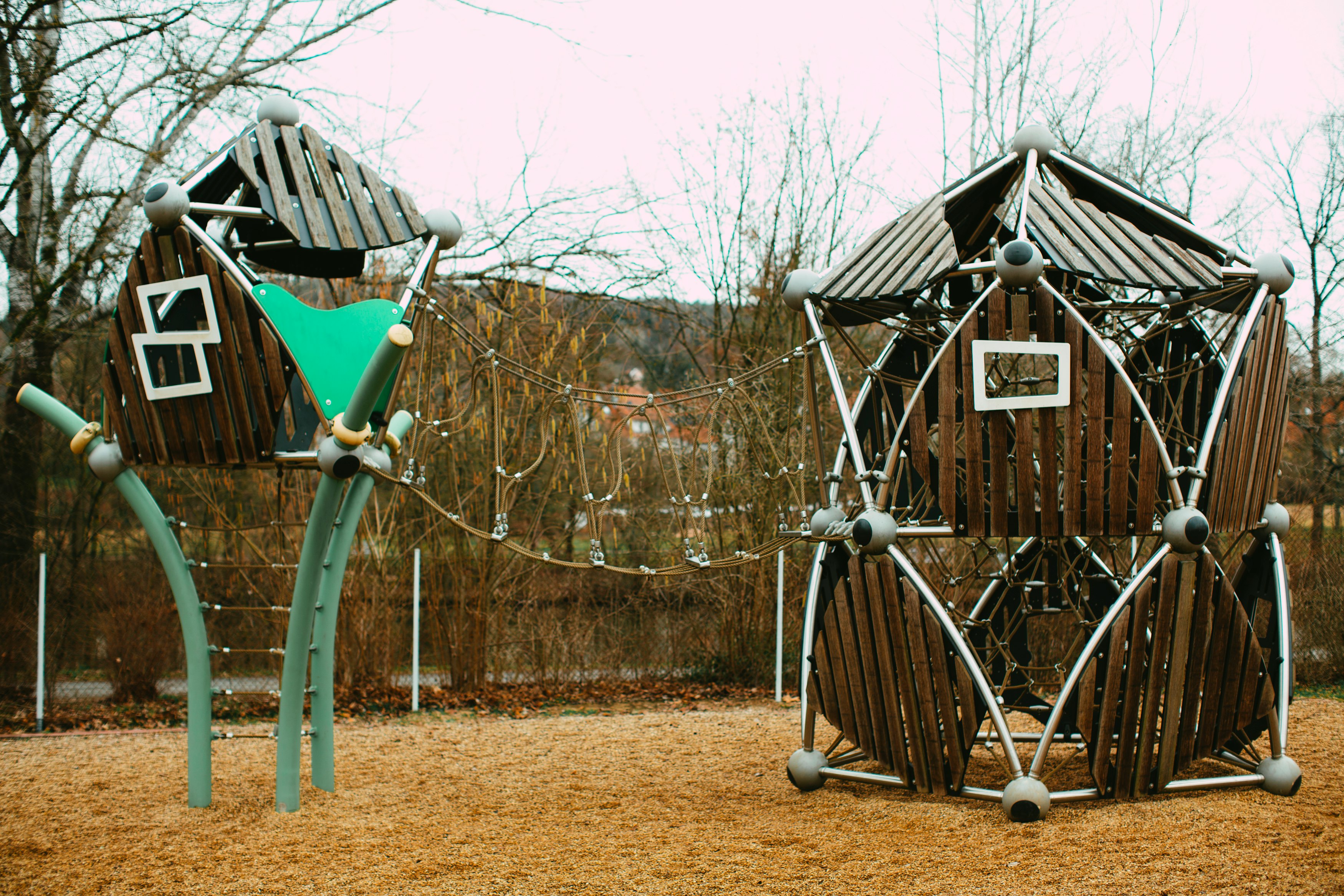 blue wooden swing near brown wooden house during daytime